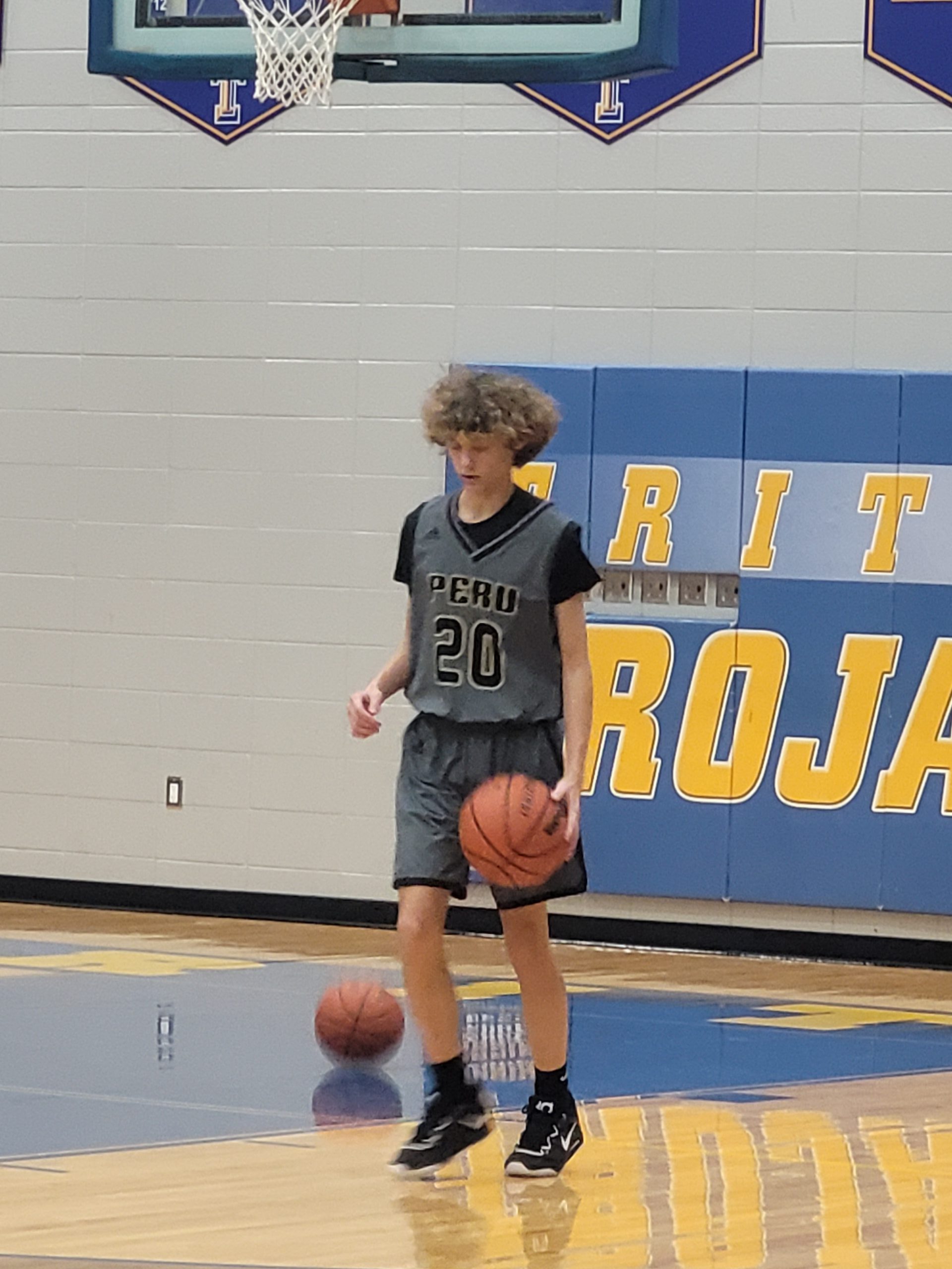 #20 Oliver Rabe dribbles the ball during warmups.